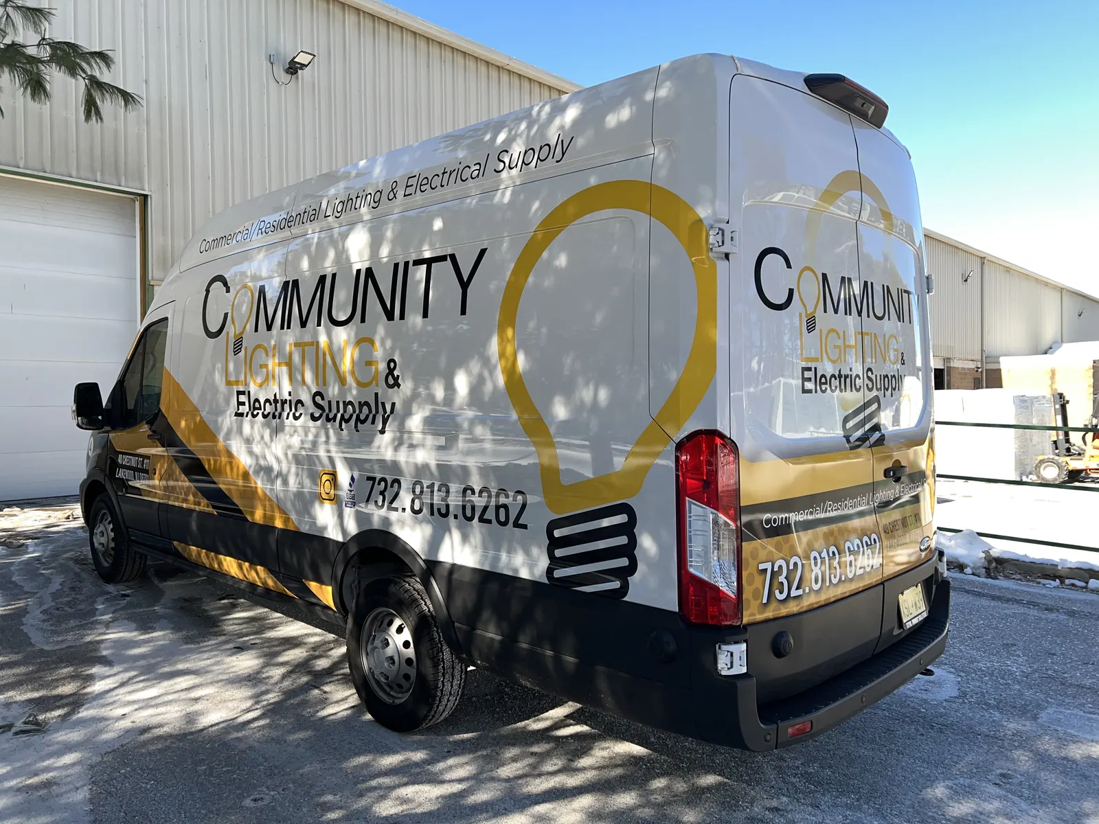COMMUNITY LIGHTING & ELECTRIC SUPPLY partial wrap — rear three-quarter