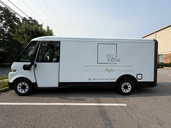 OLYMPIA BUILDERS lettering — driver side